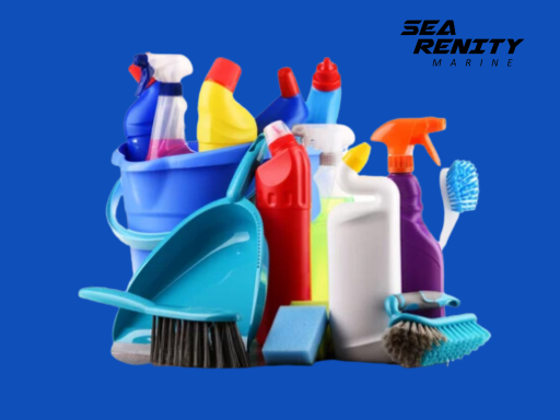 Variety of cleaning products and tools in a bucket with a blue background, featuring sprays, brushes, and detergent bottles - SEA RENITY Marine logo.